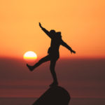 Balancing on a rock at sunset picture