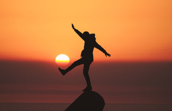 Balancing on a rock at sunset picture