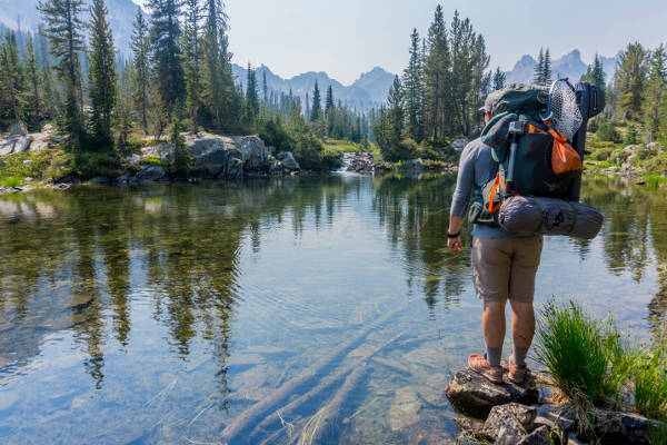 picture of back packer near water