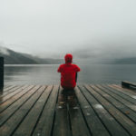 picture of red jacket at the end of a dock