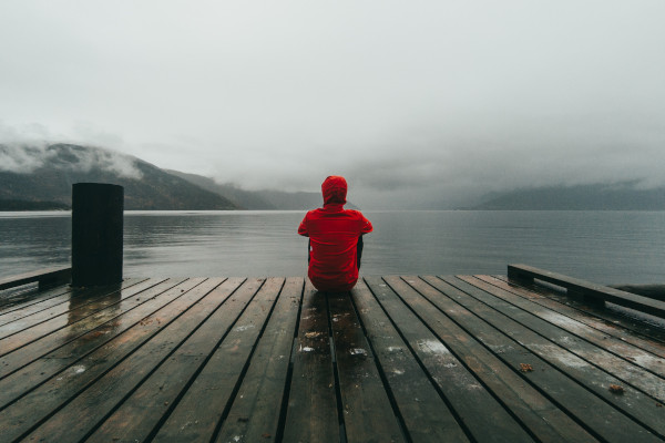 picture of red jacket at the end of a dock