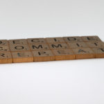 Scrabble pieces spelling commit