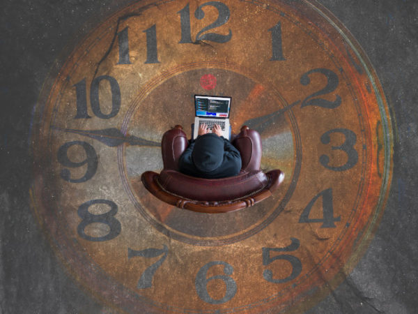 Picture of clock with laptop in the middle